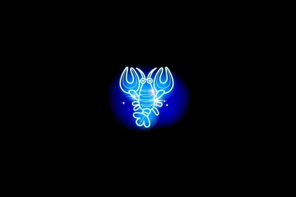 Ilustração do signo de câncer em azul sobre um fundo preto