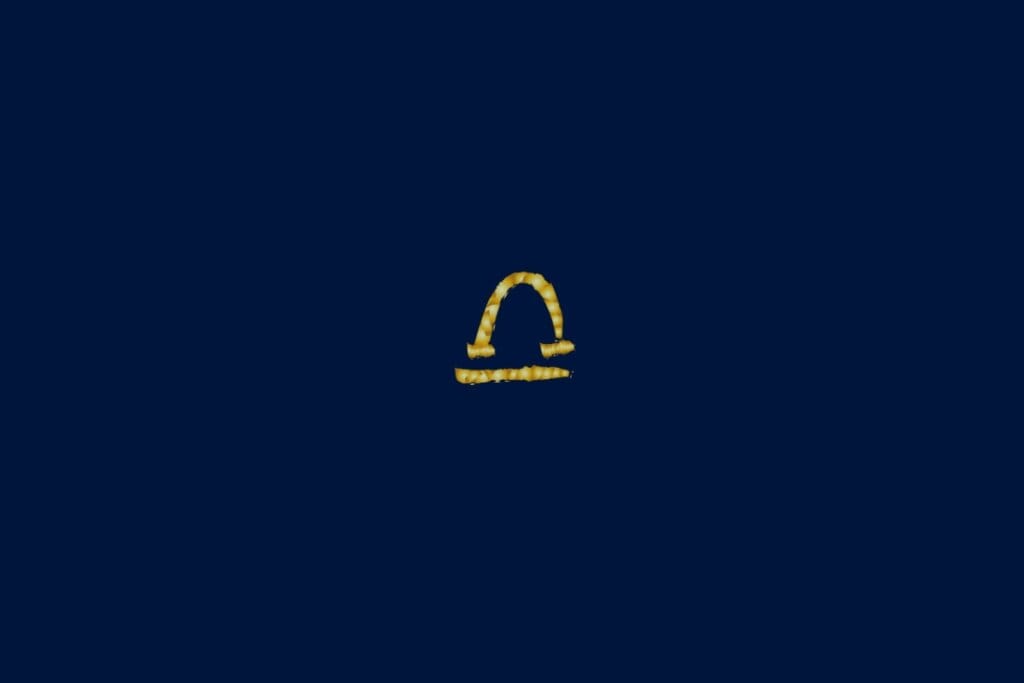 Ilustração do signo de libra em dourado e no formato de uma corda em um fundo azul-escuro