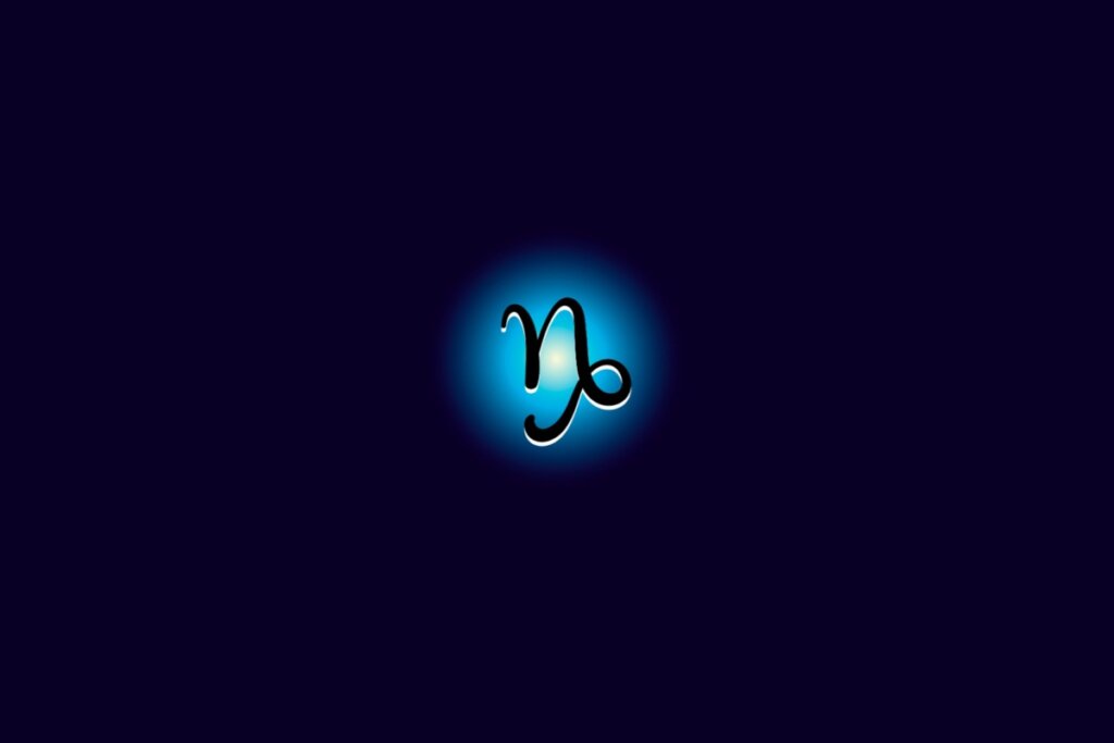 Ilustração do signo de capricórnio iluminado com uma luz em um fundo azul escuro