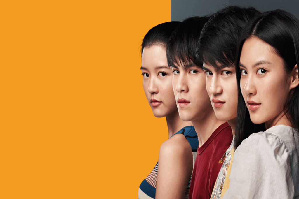 4 jovens, duas mulheres e dois homens um ao lado do outro em fundo laranja e cinza 