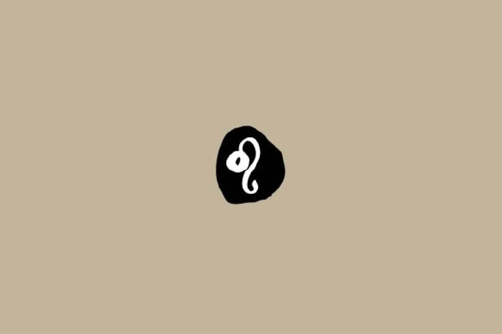 Símbolo do signo de Leão em branco dentro de um círculo preto sobre um fundo bege