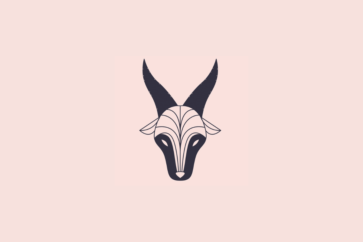 Ilustração estilizada e minimalista da cabeça de uma cabra, simbolizando o signo de capricórnio, em tom azul-escuro sobre um fundo rosa-claro
