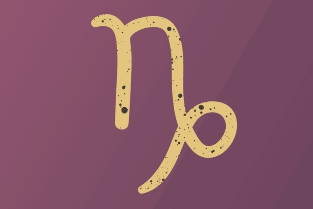 A imagem apresenta o símbolo do signo de capricórnio em tom dourado, centralizado sobre um fundo roxo escuro. O símbolo possui pequenos detalhes e manchas escuras que criam um efeito texturizado e artístico.